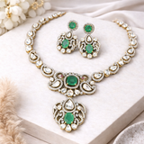 Ornate Silver necklace and earrings with green gemstones 