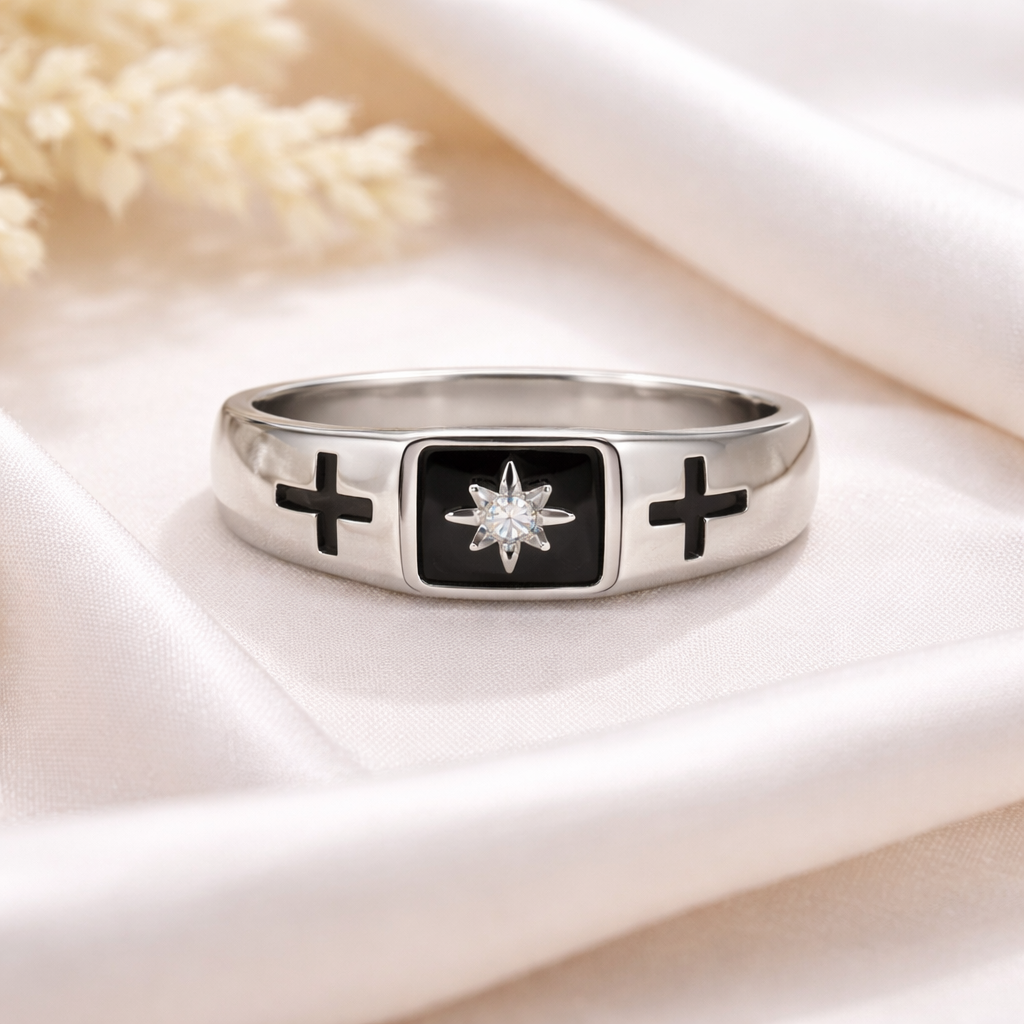 Silver ring with black crosses and a star design 