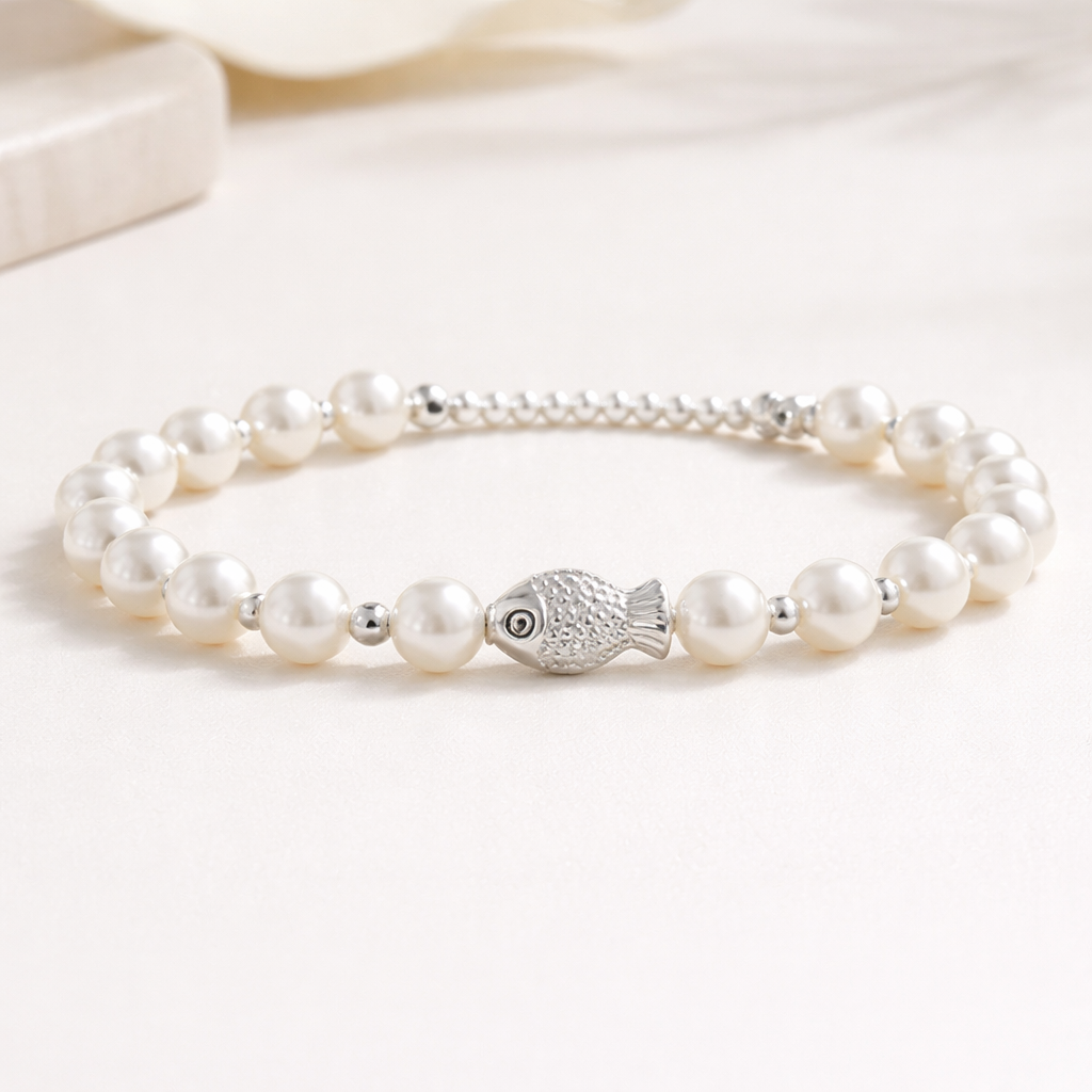 Sterling silver fish charm bracelet made with white pearls