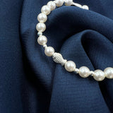 Pearl bracelet with silver fish charm
