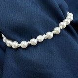Pearl necklace with a silver fish-shaped bracelet