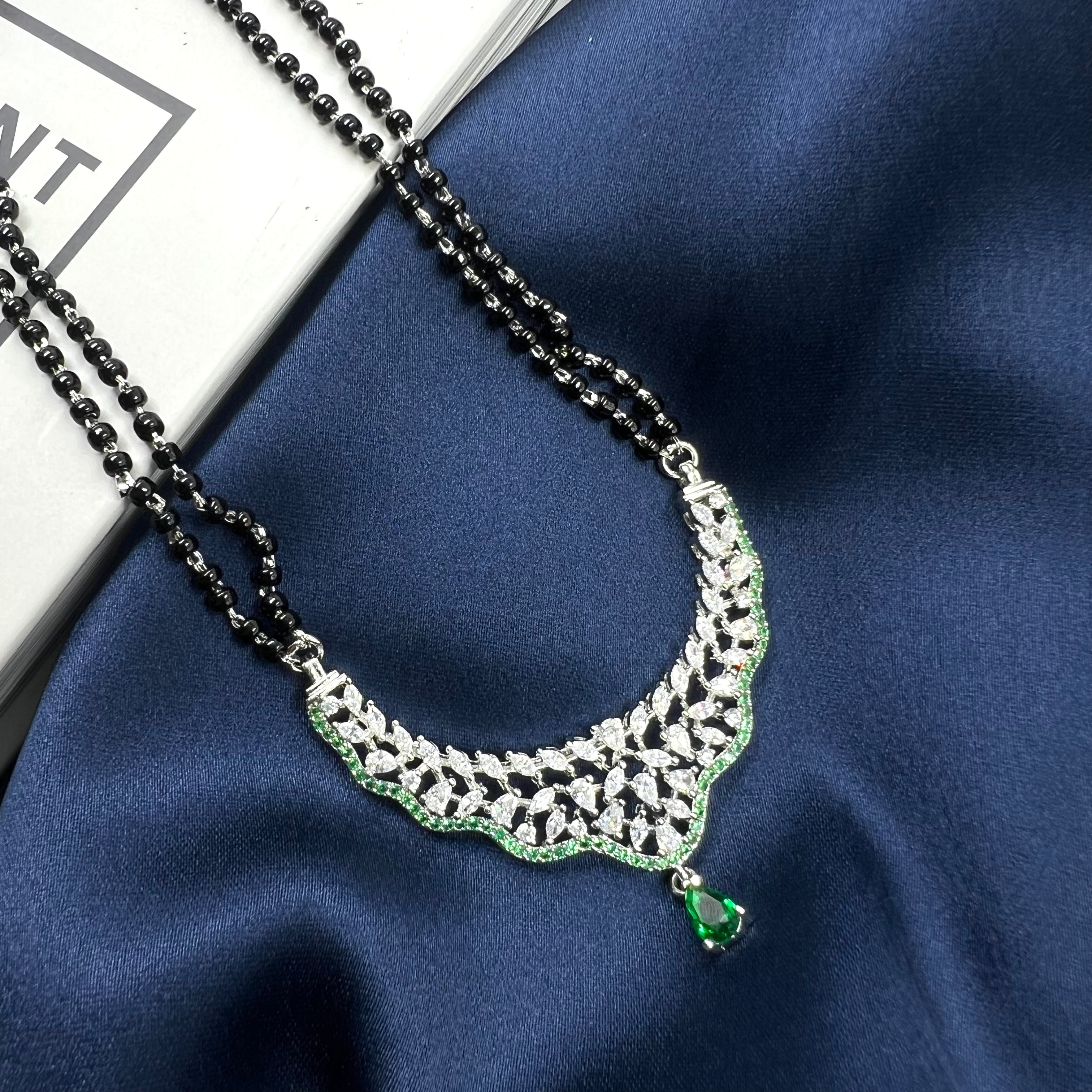 mangalsutra chain with silver cz pendant and green stone drop.