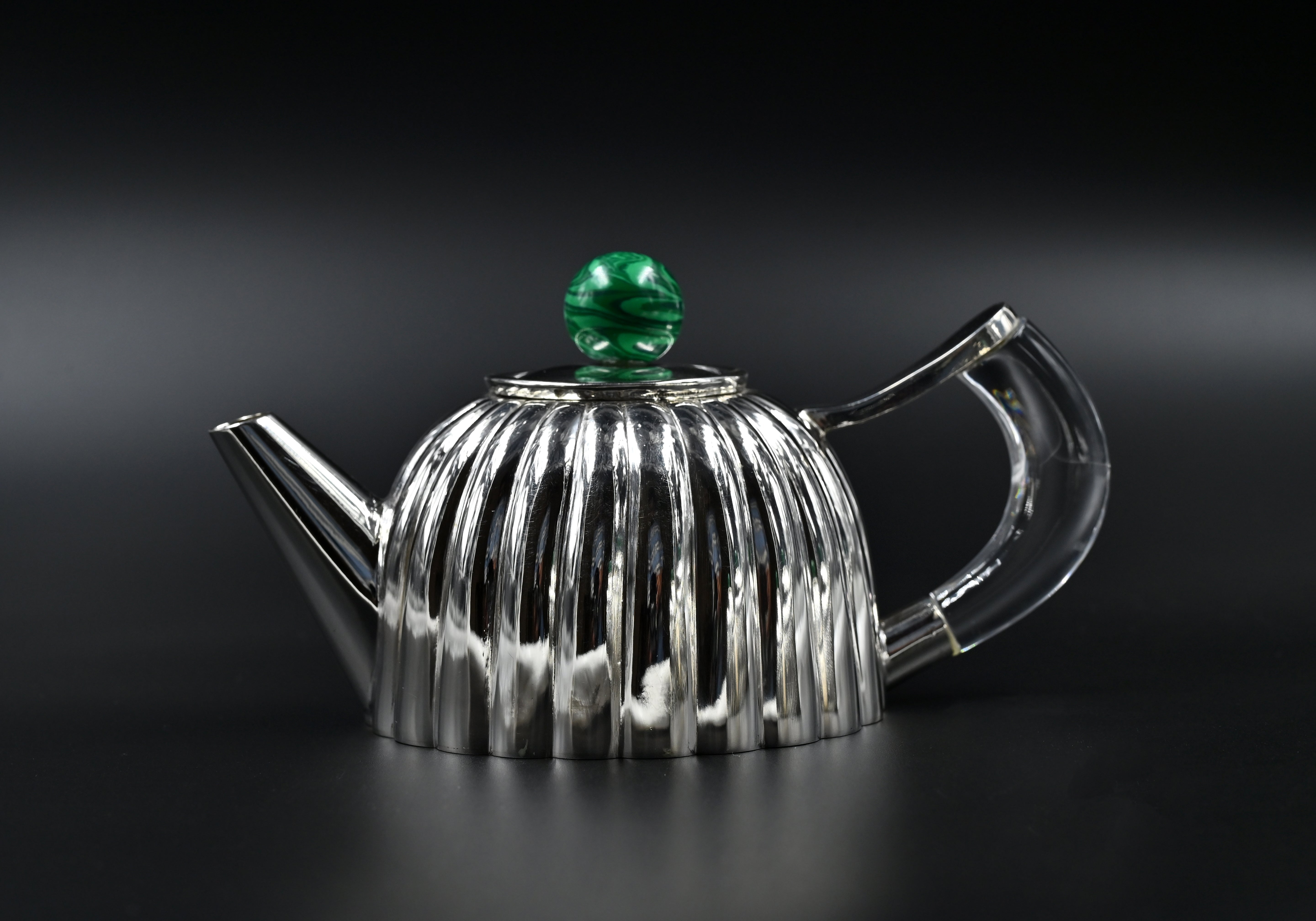 Silver teapot and matcher cups for chai
