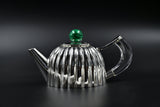 Silver teapot and matcher cups for chai